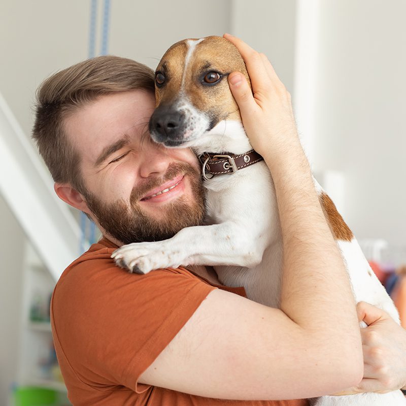 Man Hugging Dog