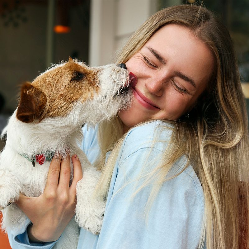 Women Getting Dog Kisses